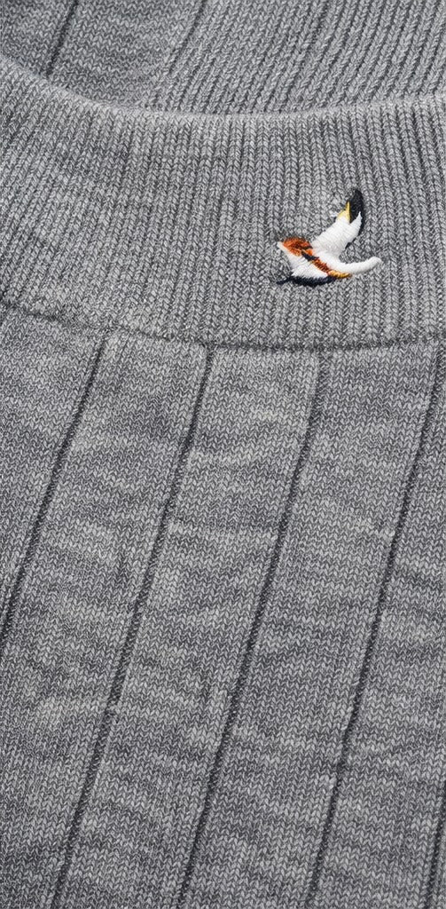 Gray fabric detail  with a small embroidered design