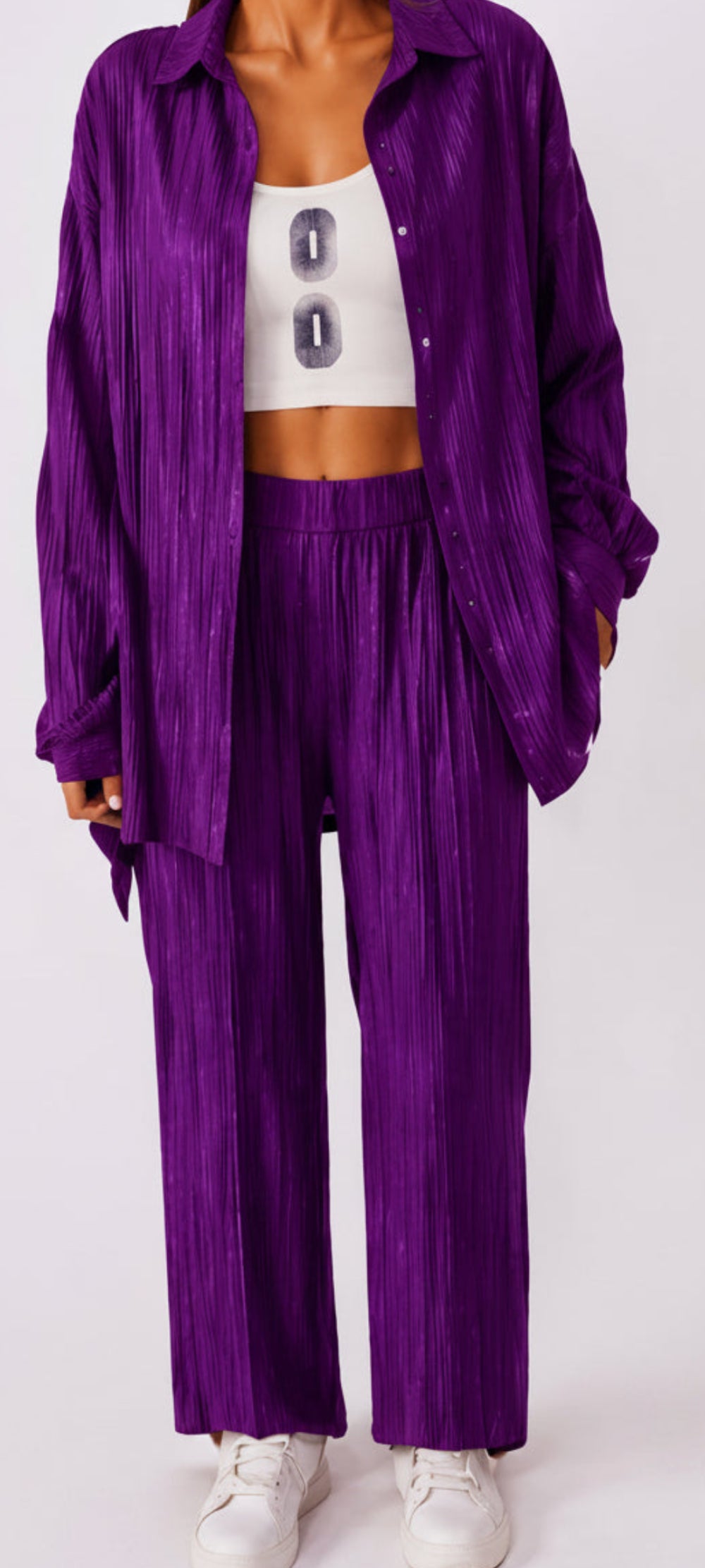Purple outfit with a white top on a plain background