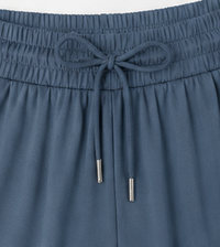 Close-up of blue pants with drawstring waistband