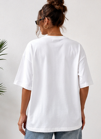Person wearing a white t-shirt on a plain background