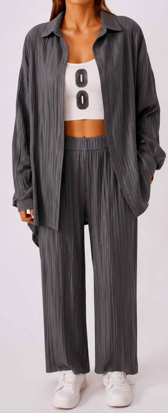 Person wearing a black outfit with a white top featuring the number '00' on a light gray background