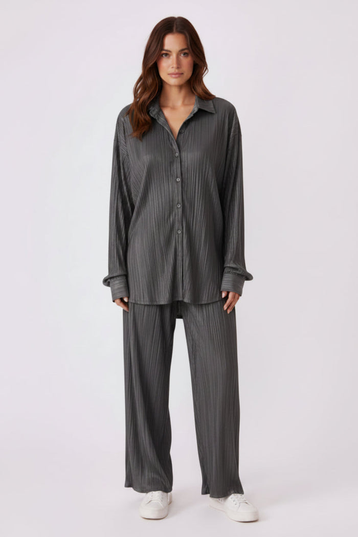 Woman wearing a black outfit with a white background