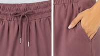 Mauve trouser close upwith drawstring and pocket detail on a light gray background