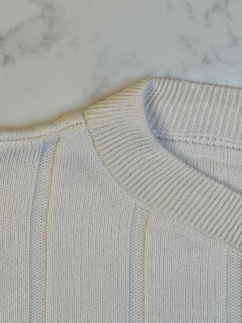 Close-up of a light blue sweater on a marble surface