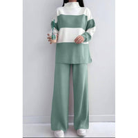 Person wearing a green and white outfit holding a Starbucks cup against a plain background