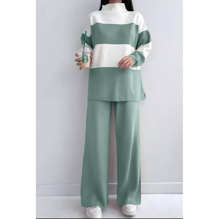 Person wearing a green and white outfit holding a Starbucks cup against a plain background