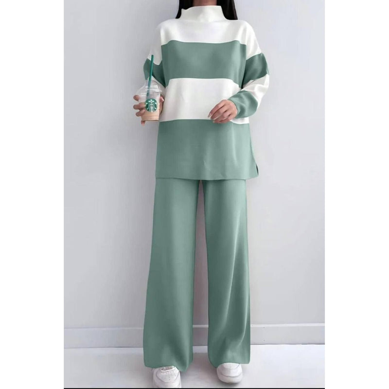 Person wearing a green and white outfit holding a Starbucks cup against a plain background