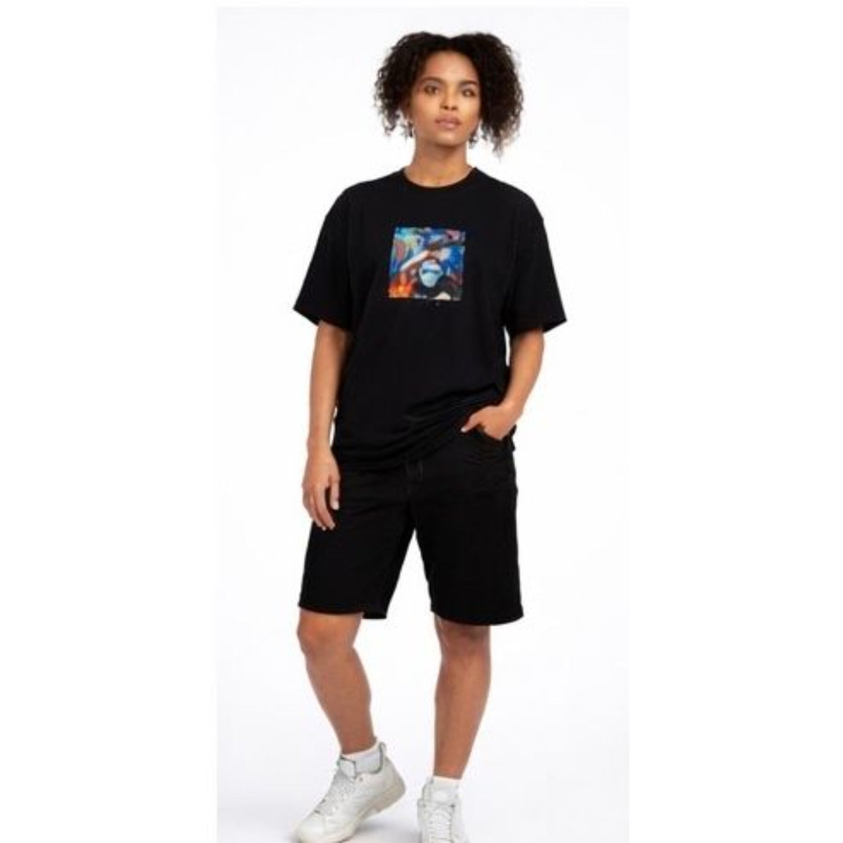 Person wearing a black t-shirt with a colorful graphic design on a white background