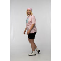 Person wearing a pink t-shirt, black shorts, and white sneakers on a white background