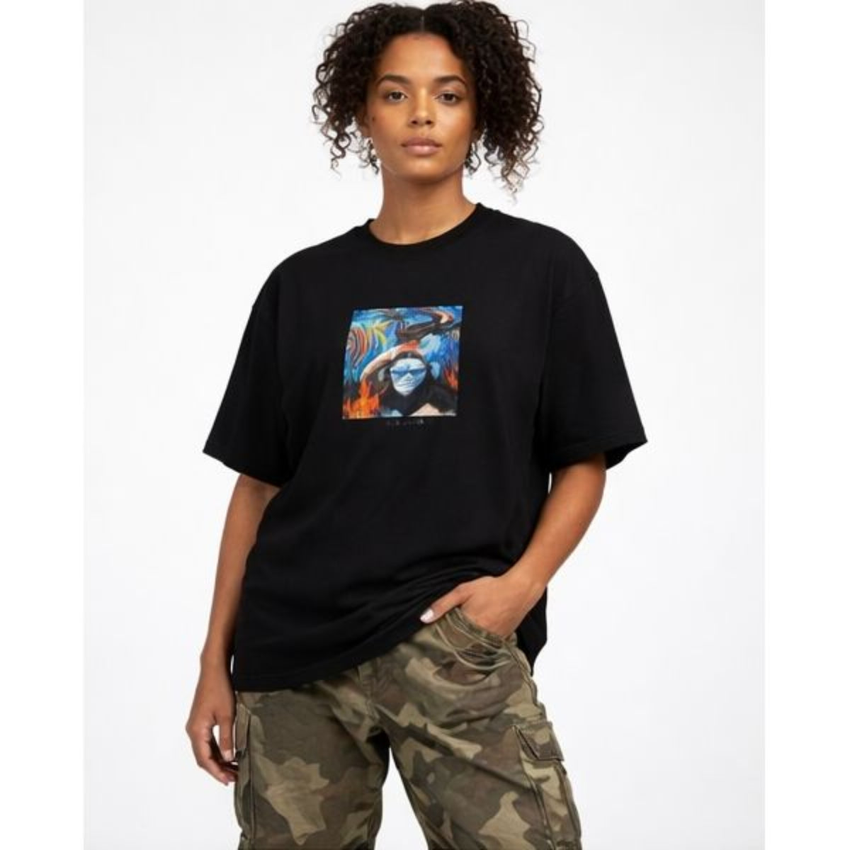 Person wearing a black t-shirt with a colorful graphic design on a white background