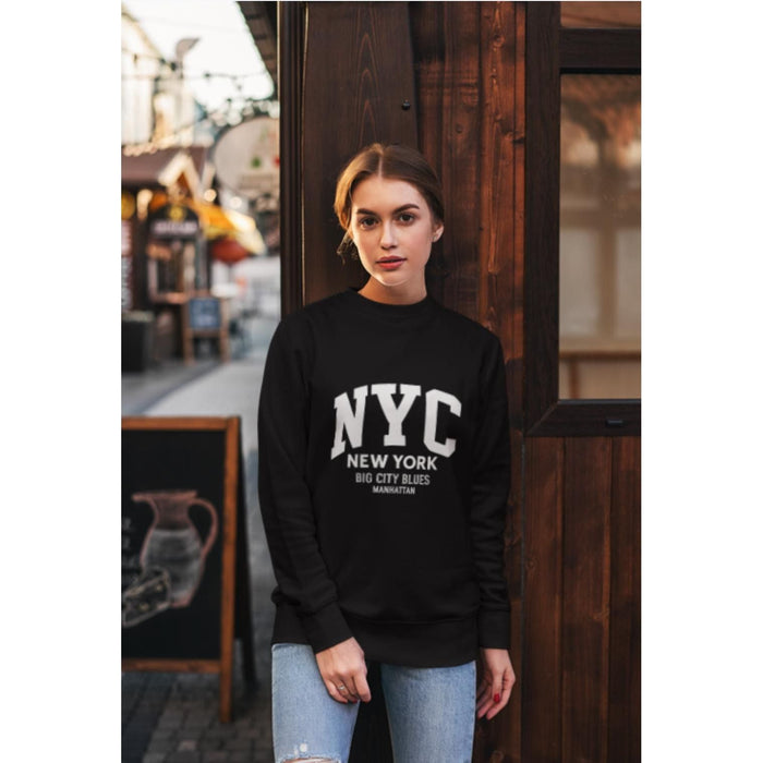 Woman wearing a black sweatshirt with 'NYC New York Big City Blues' text, standing in an urban setting.