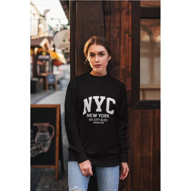 Woman wearing a black sweatshirt with 'NYC New York Big City Blues' text, standing in an urban setting.