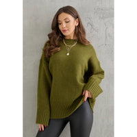 Woman wearing a green sweater against a gray background