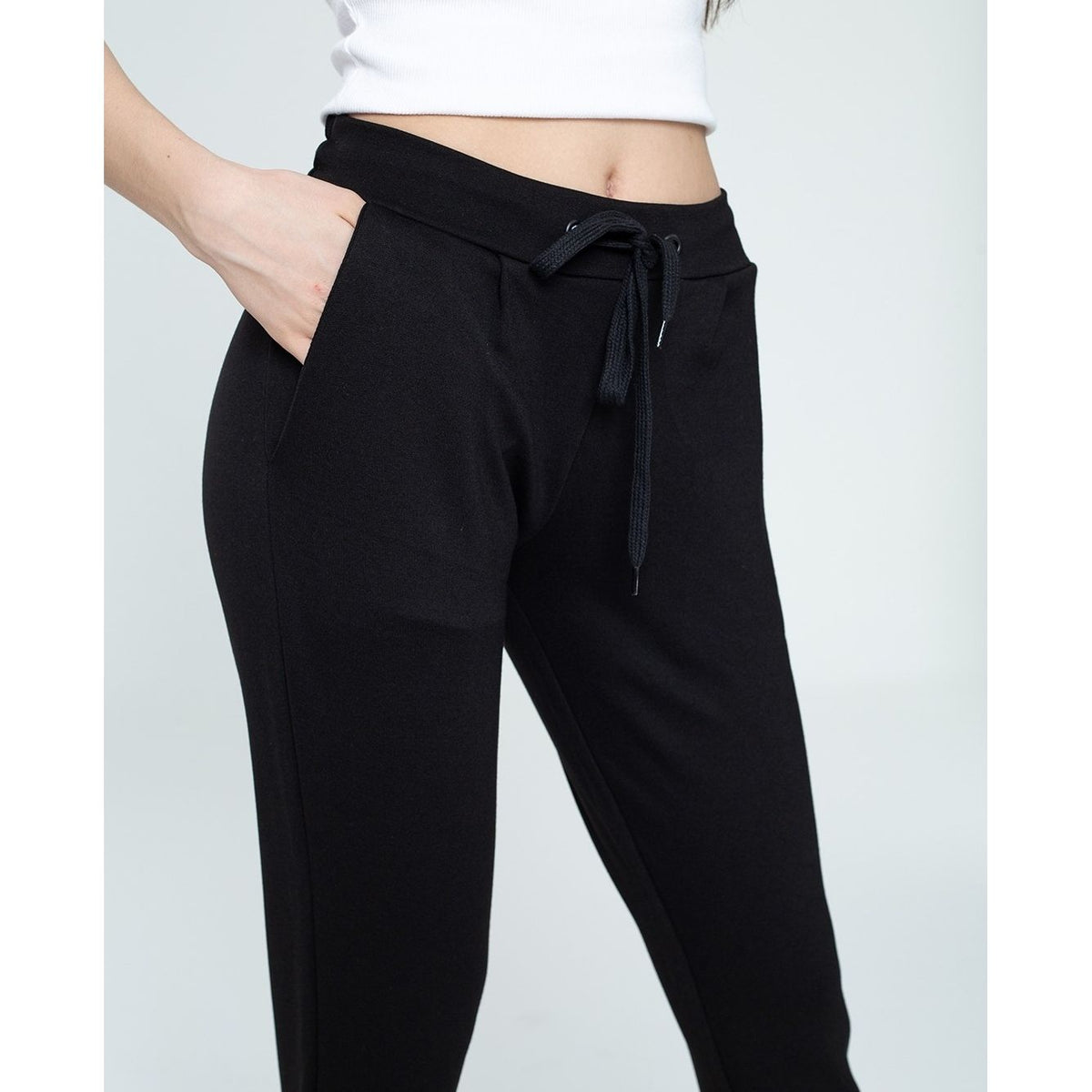 Black pants with a tie waist on a white background