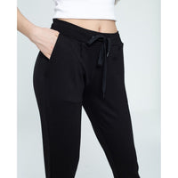 Black pants with a tie waist on a white background